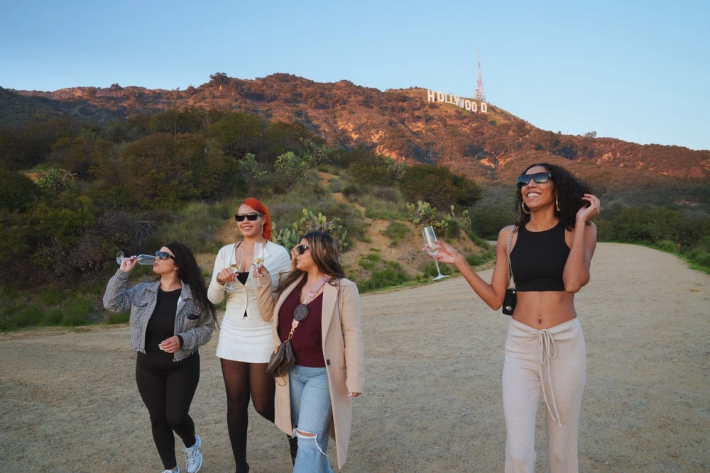 Private Hollywood tour guests near hiking trail with Hollywood Sign view