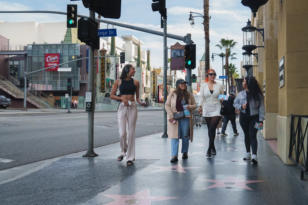 Visitors walking along the Hollywood Walk of Fame during a guided tour