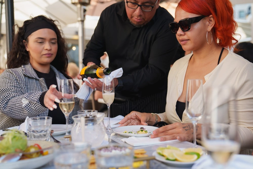 Private Hollywood tour guests enjoying champagne at restaurant